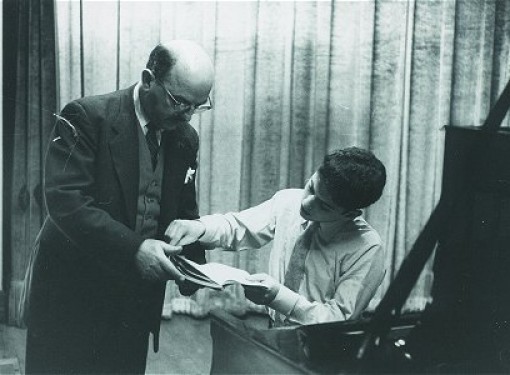 With his father studying a score